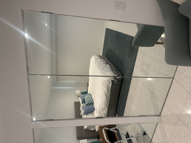 Full-length bedroom mirror installation