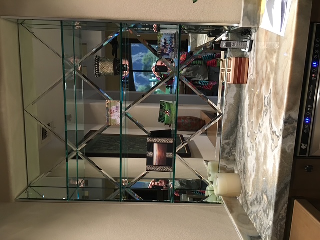 Custom mirrored bar wall with diamond lattice grid and stone countertop