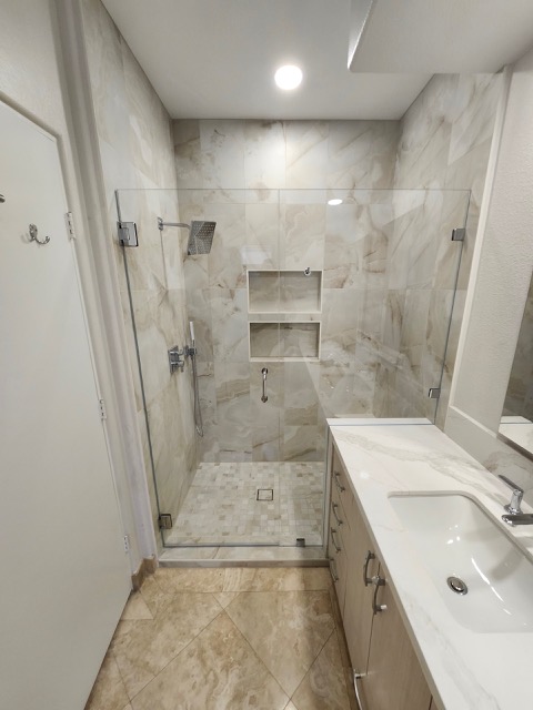 Frameless glass shower enclosure